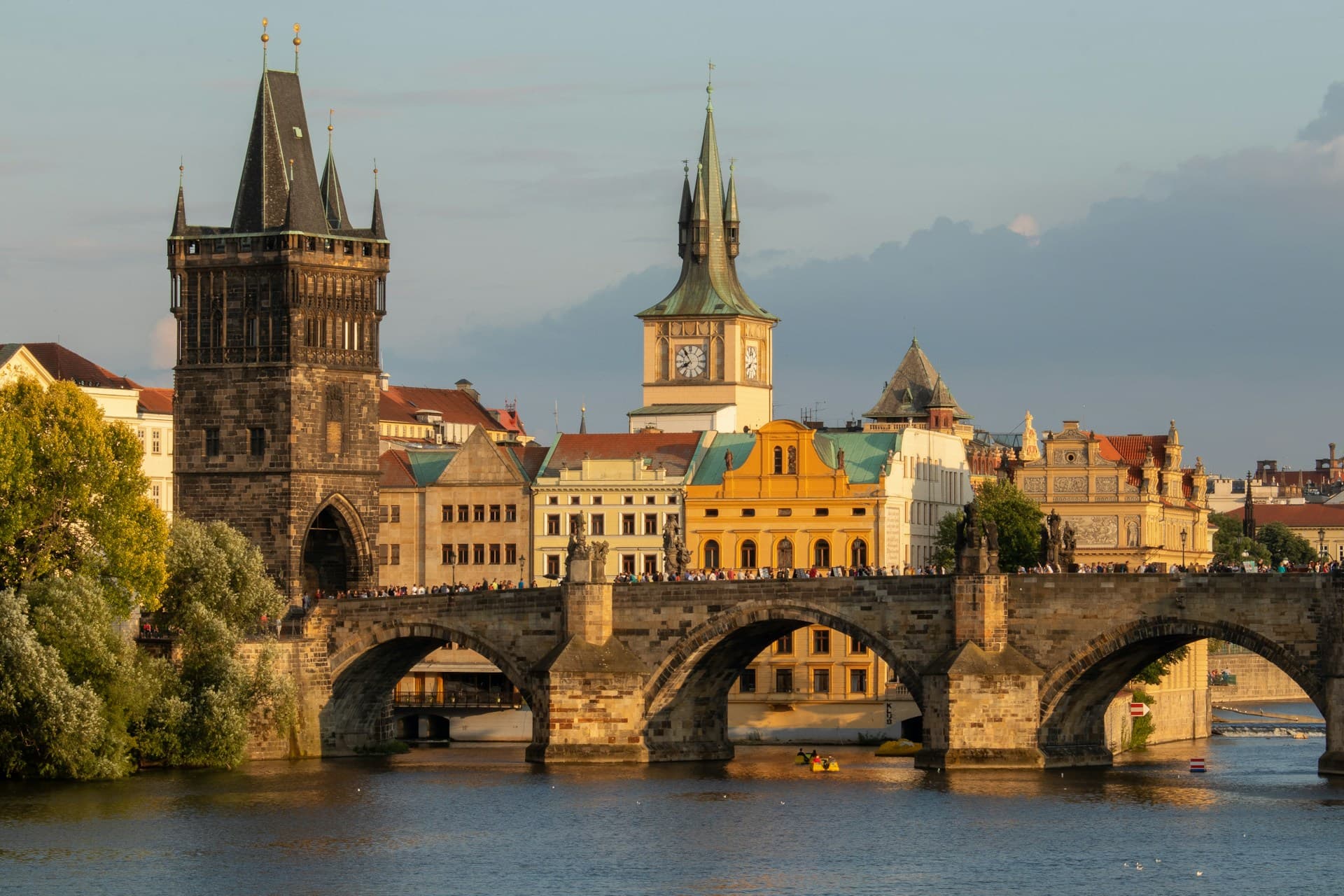 Prague Castle and Charles Bridge illuminated at night, showcasing the city's magical atmosphere
